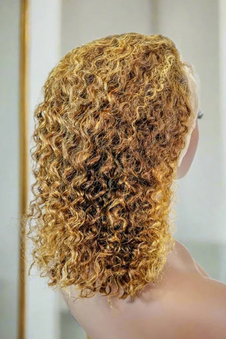 Curly human hair wig with honey blonde highlights, natural volume and texture for versatile styling