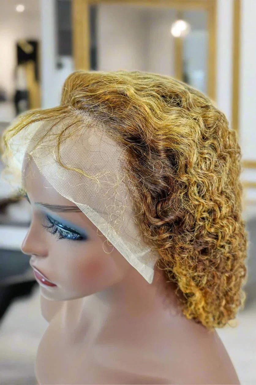 Curly human hair wig with lace front on mannequin, natural ombre blonde and brown tones