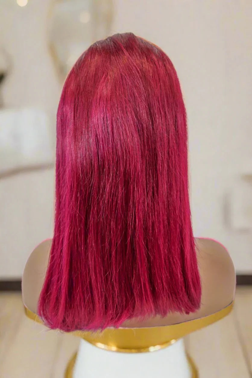 Vibrant red human hair wig on mannequin, sleek straight style for natural look