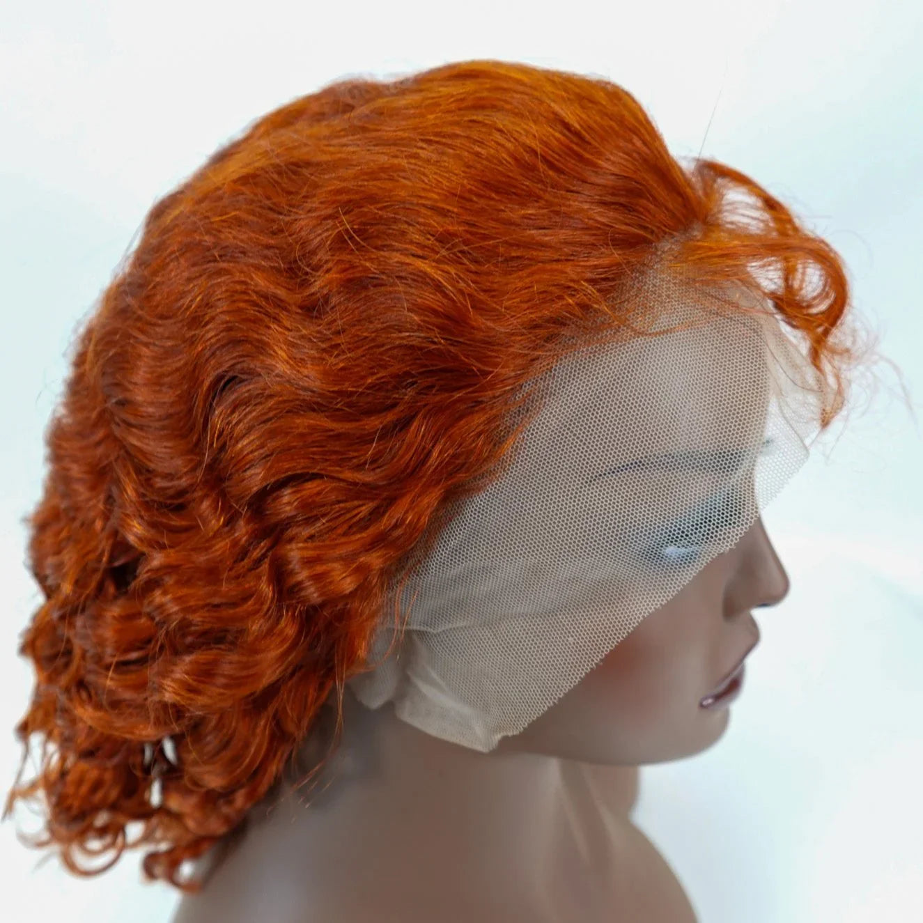 Vibrant red curly human hair lace front wig on mannequin, natural styling ready