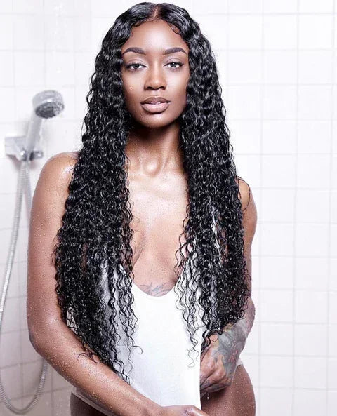 Woman with long, curly human hair wig in shower, showcasing natural volume and texture for styling