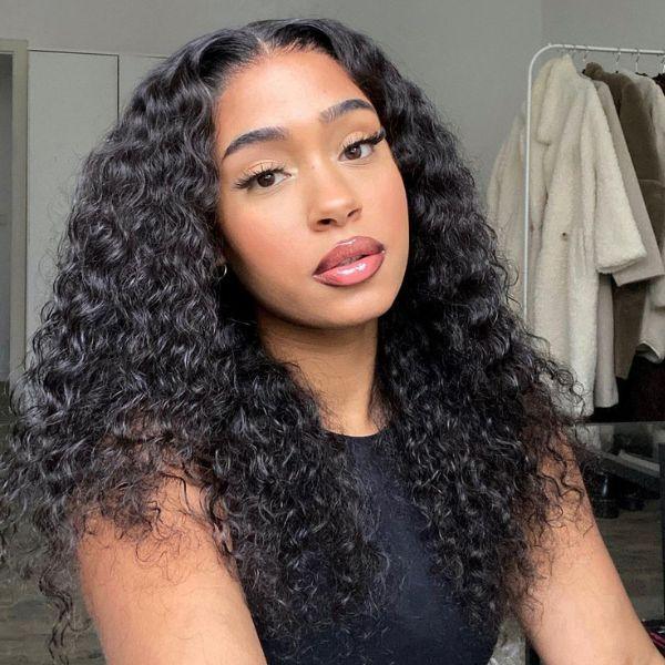 Woman wearing voluminous curly human hair wig, natural styling for everyday beauty