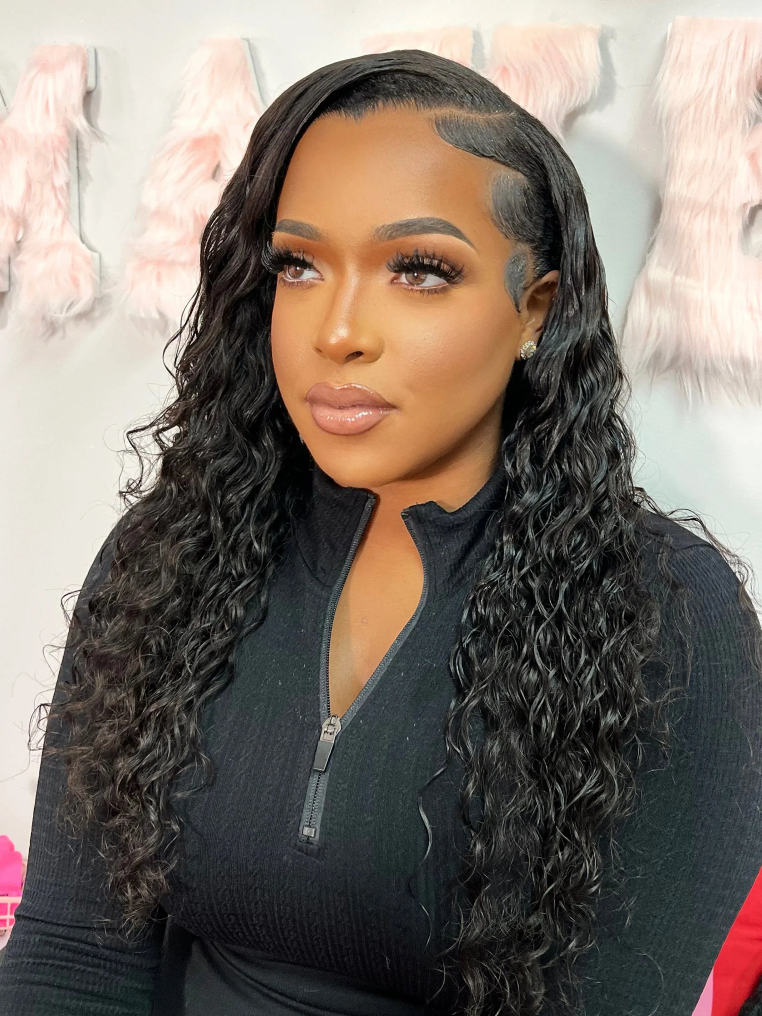 Woman wearing a natural-looking human hair wig with deep waves and a seamless lace front, styled for everyday elegance.