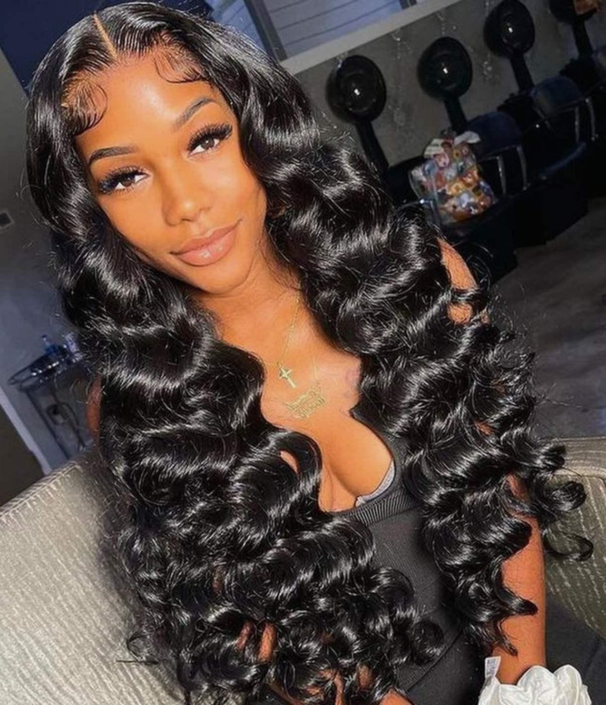 Woman wearing voluminous deep wave human hair wig with natural-looking lace front
