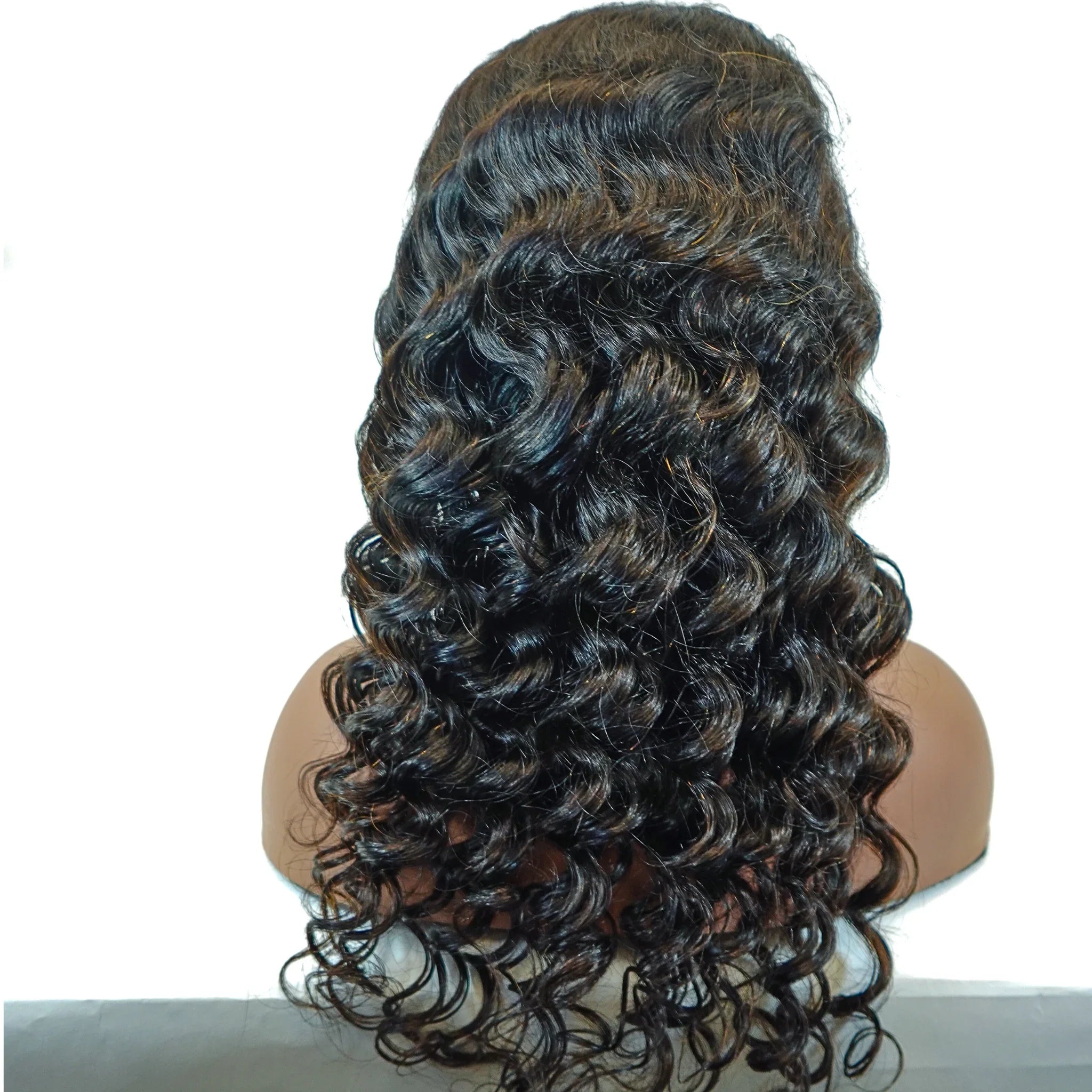 Deep wave human hair wig with natural-looking curls and highlights on mannequin head