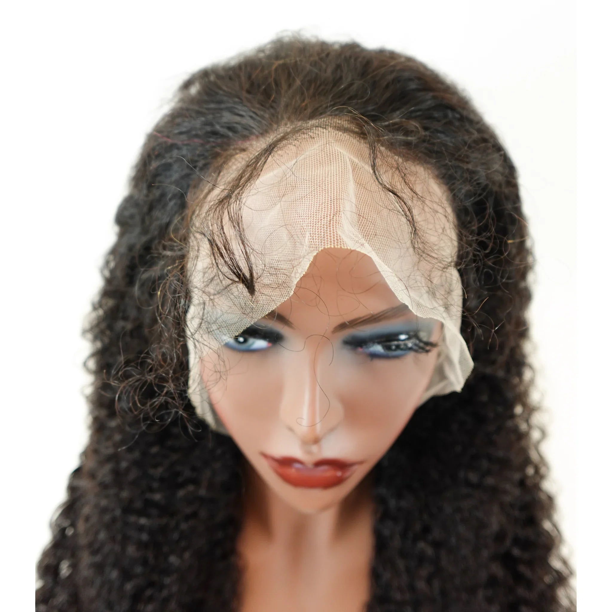 Curly human hair wig with lace front on mannequin, natural styling ready