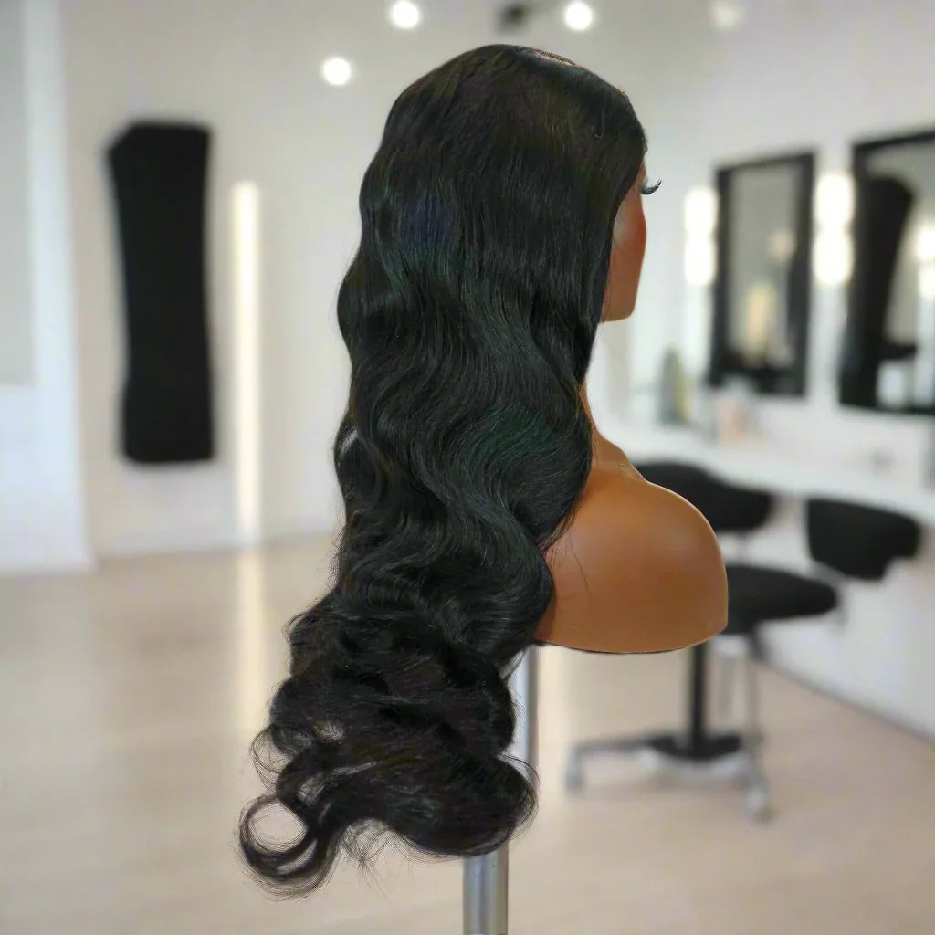 Long body wave human hair wig on mannequin in salon setting, natural styling ready