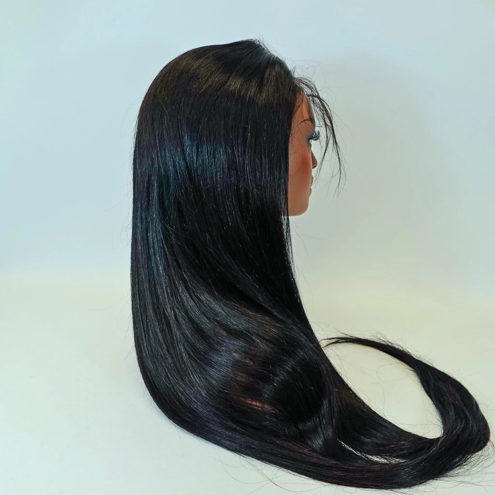 Long straight human hair wig with natural shine, sleek black strands on mannequin head