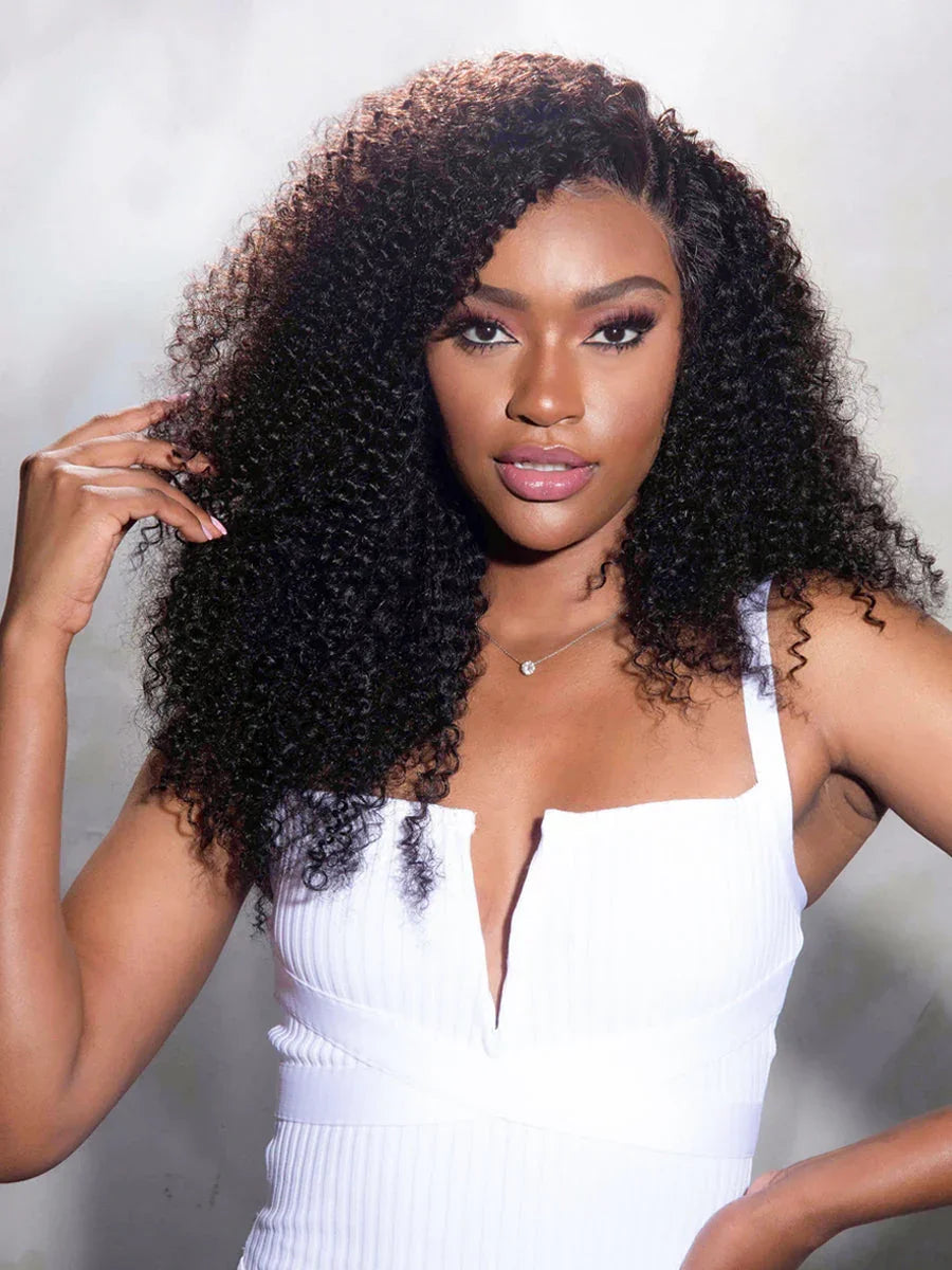 Woman with voluminous curly human hair wig, natural styling, wearing white dress