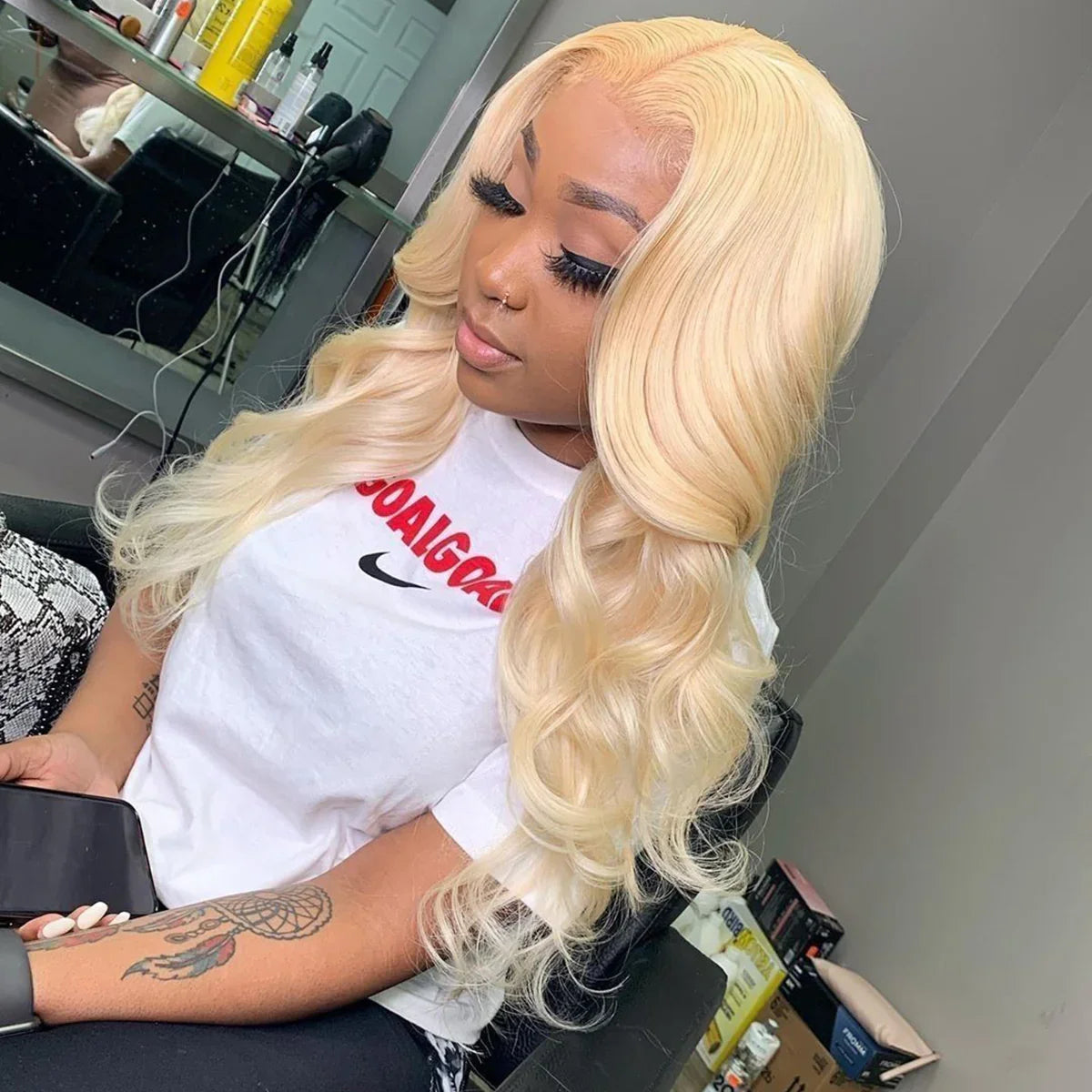 Blonde human hair wig with natural waves, styled in a salon setting for everyday wear